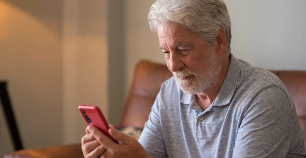 Mature handsome man text and write message on the smartphone