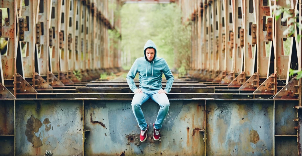 sad man on the abandoned bridge