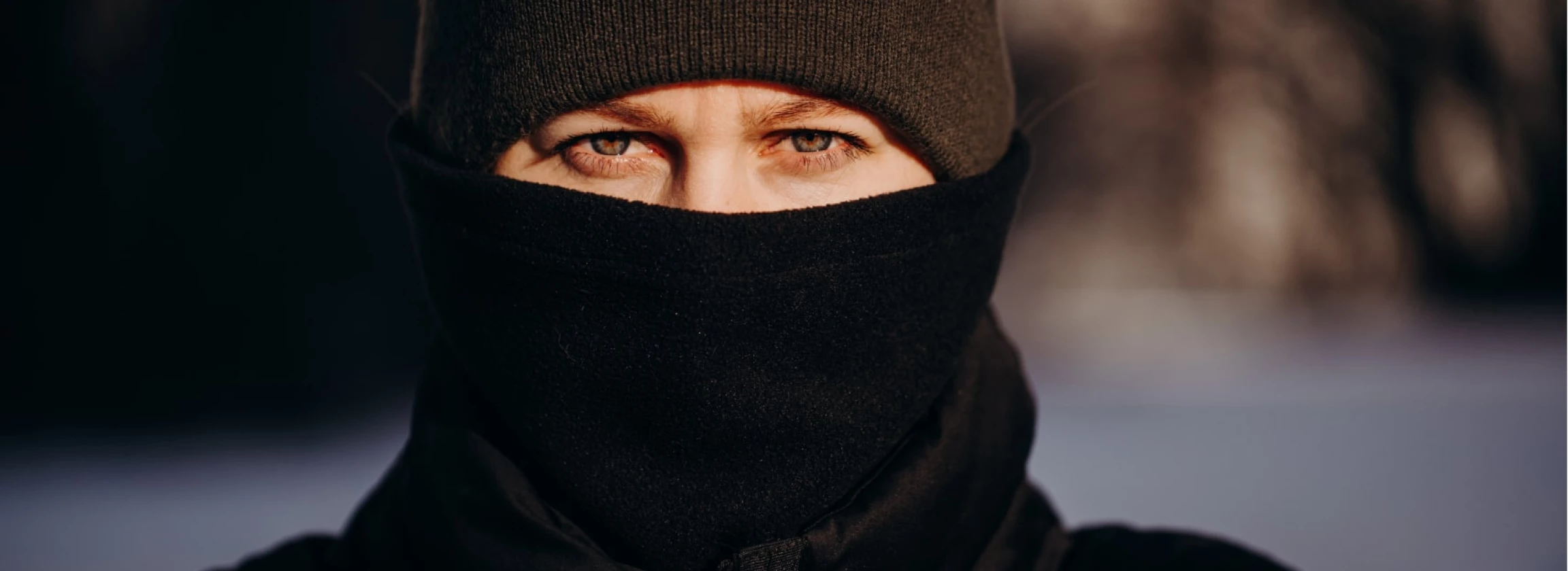 a black winter outfit covering the travelers face