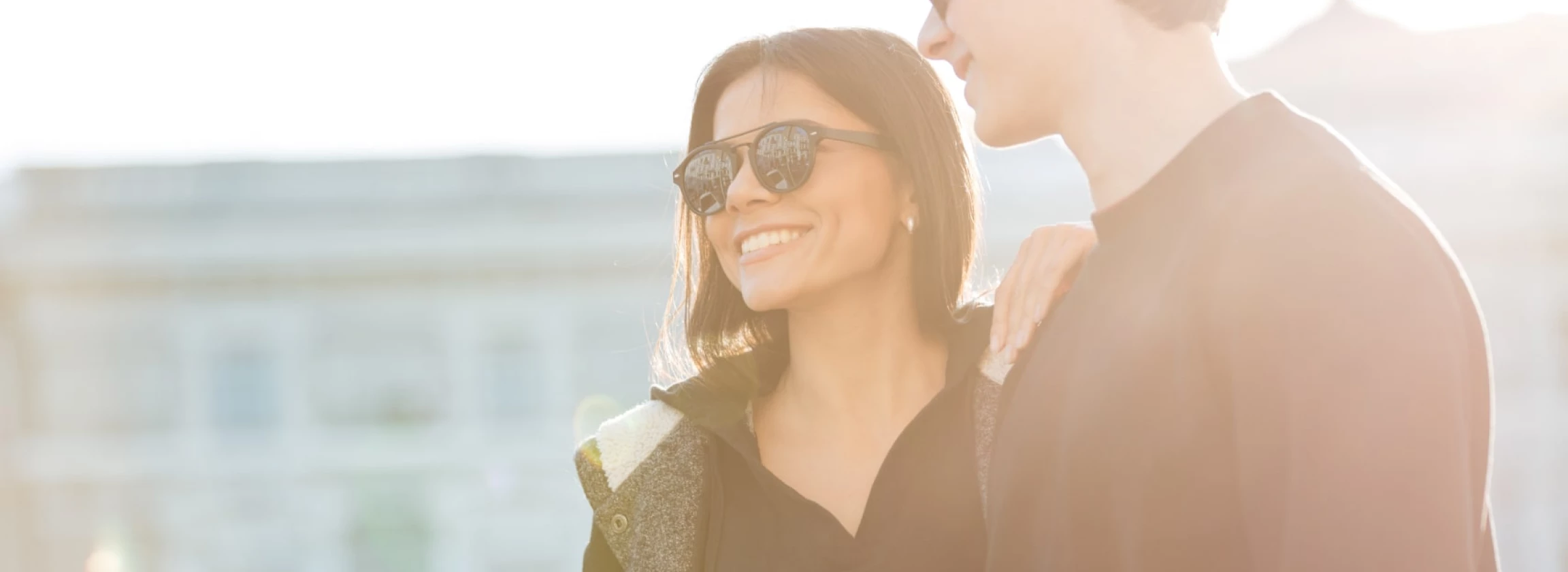 happy young woman walking outdoors with her brother