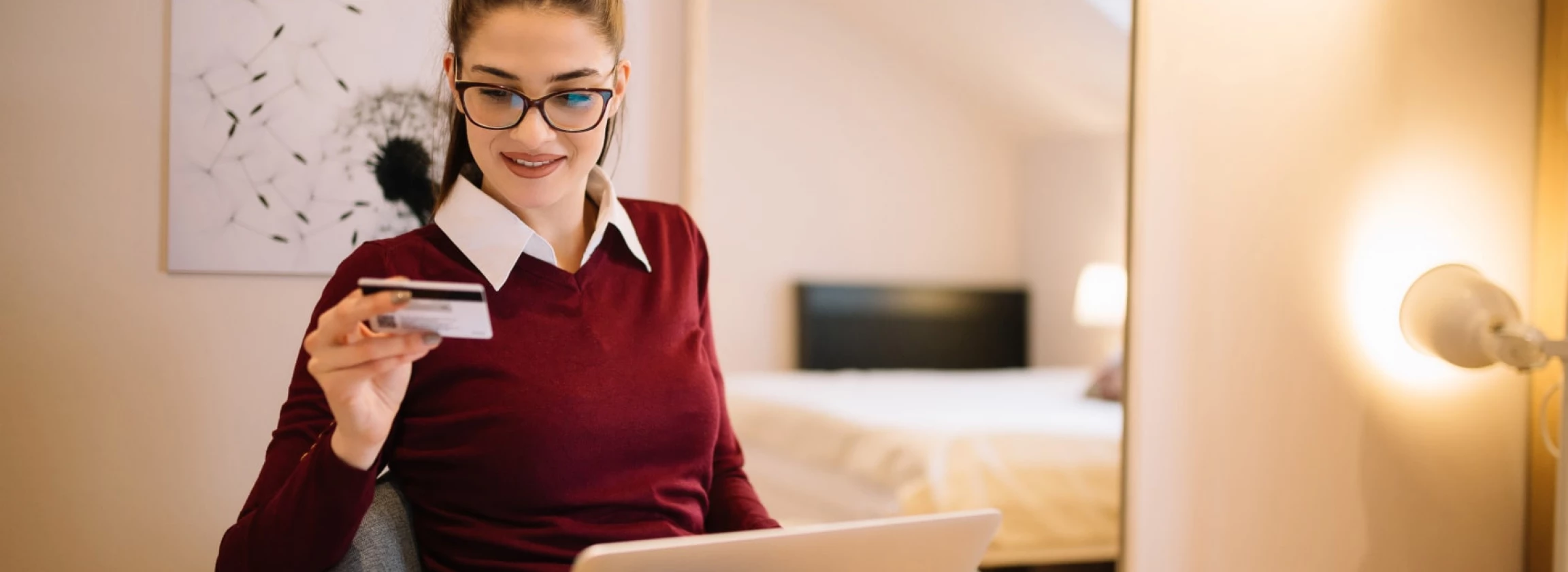 attractive girl shopping online sitting in a chair at her comfortable home