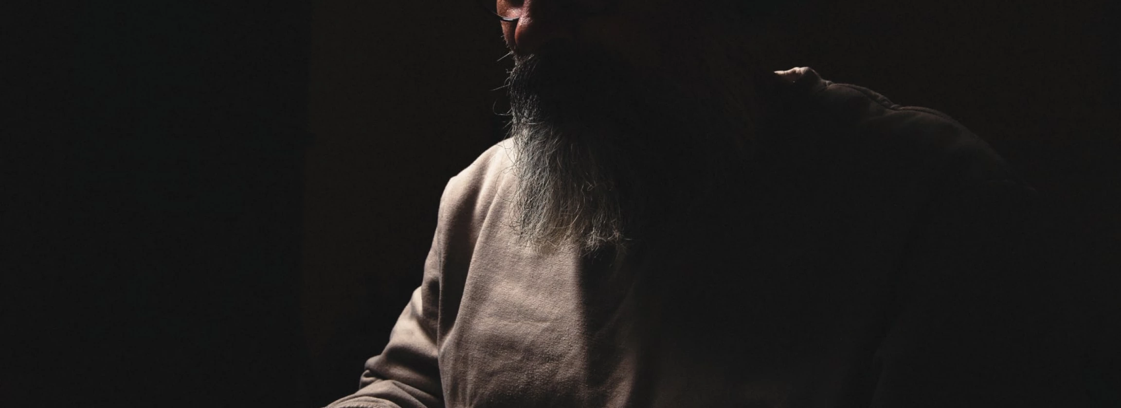 bearded man at a laptop at night internet addiction concept