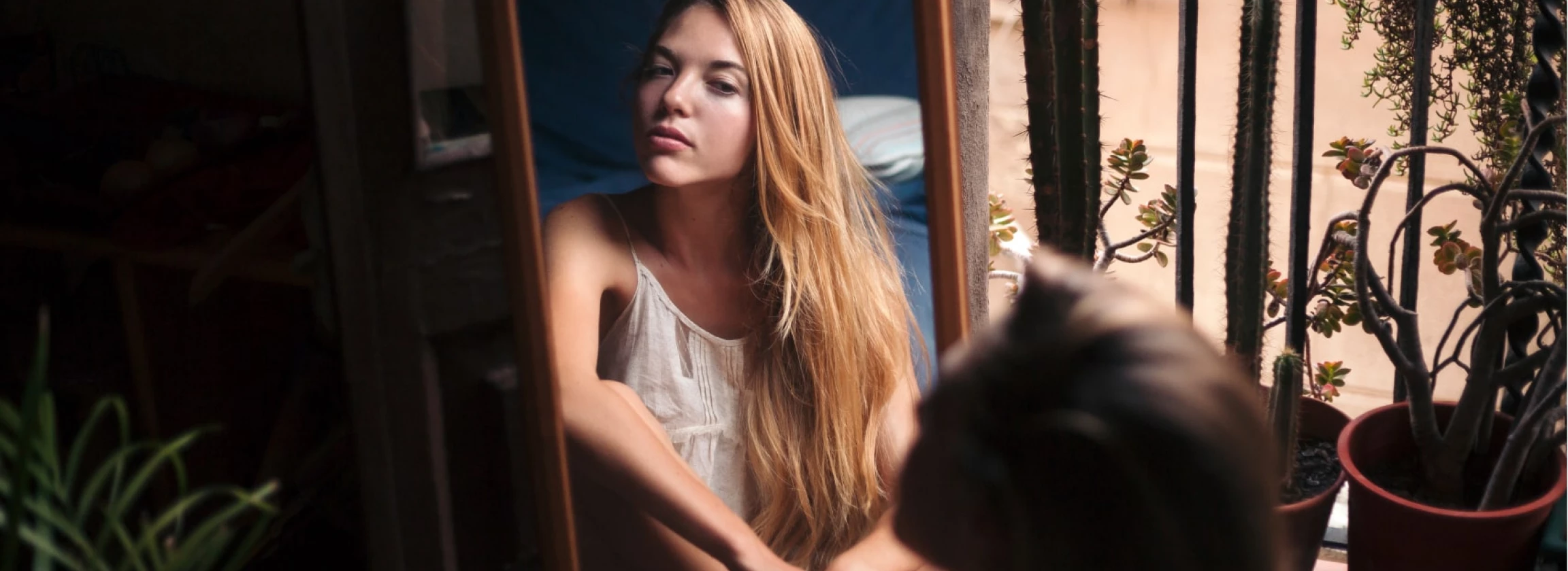 mirror image of young woman watching herself