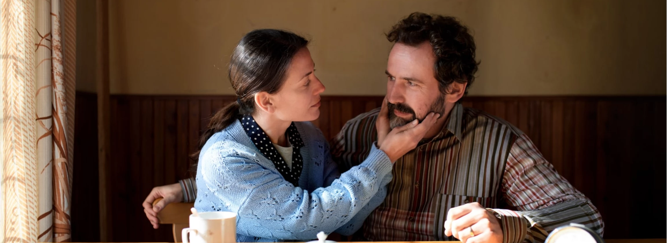portrait of poor mature couple in love indoors at home