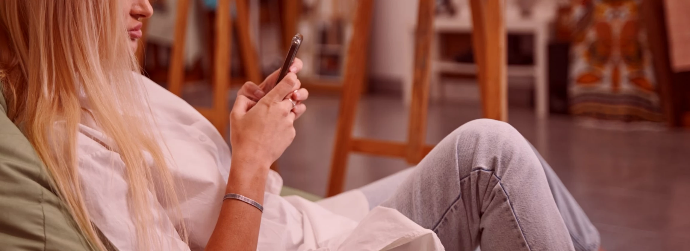 blonde lady sitting on a beanbag in her profile photo