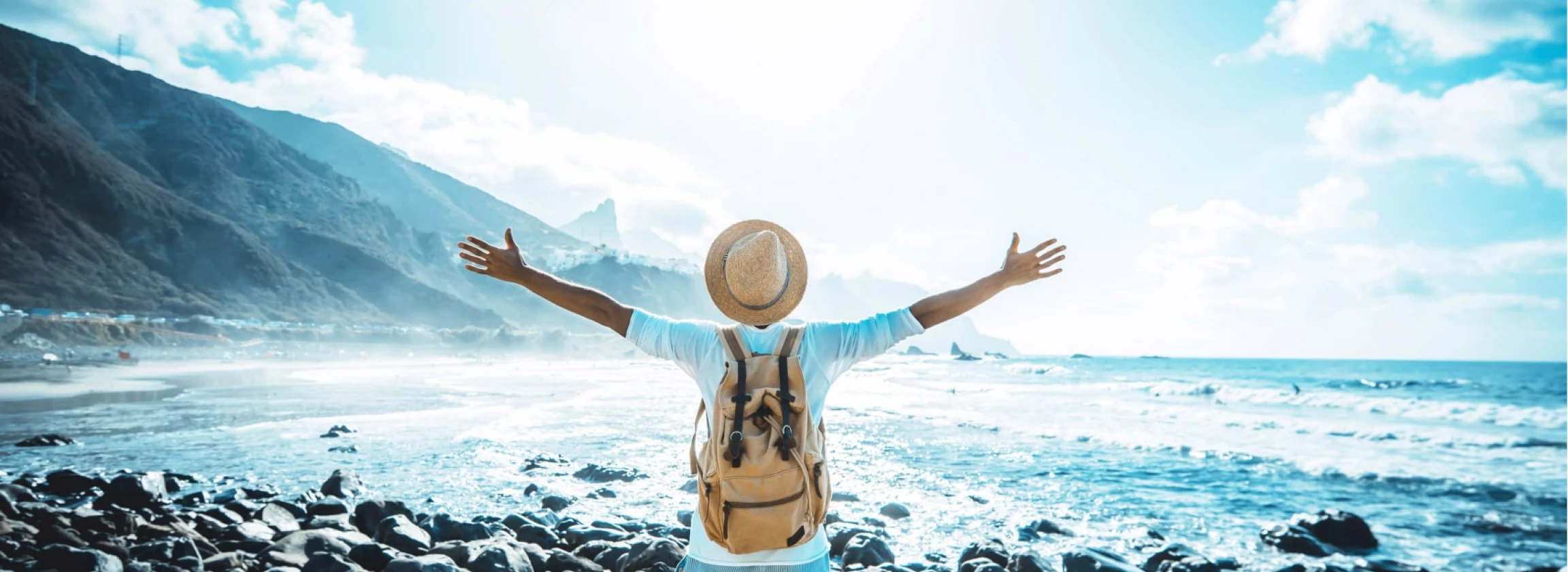 happy man with arms up enjoying freedom on the beach