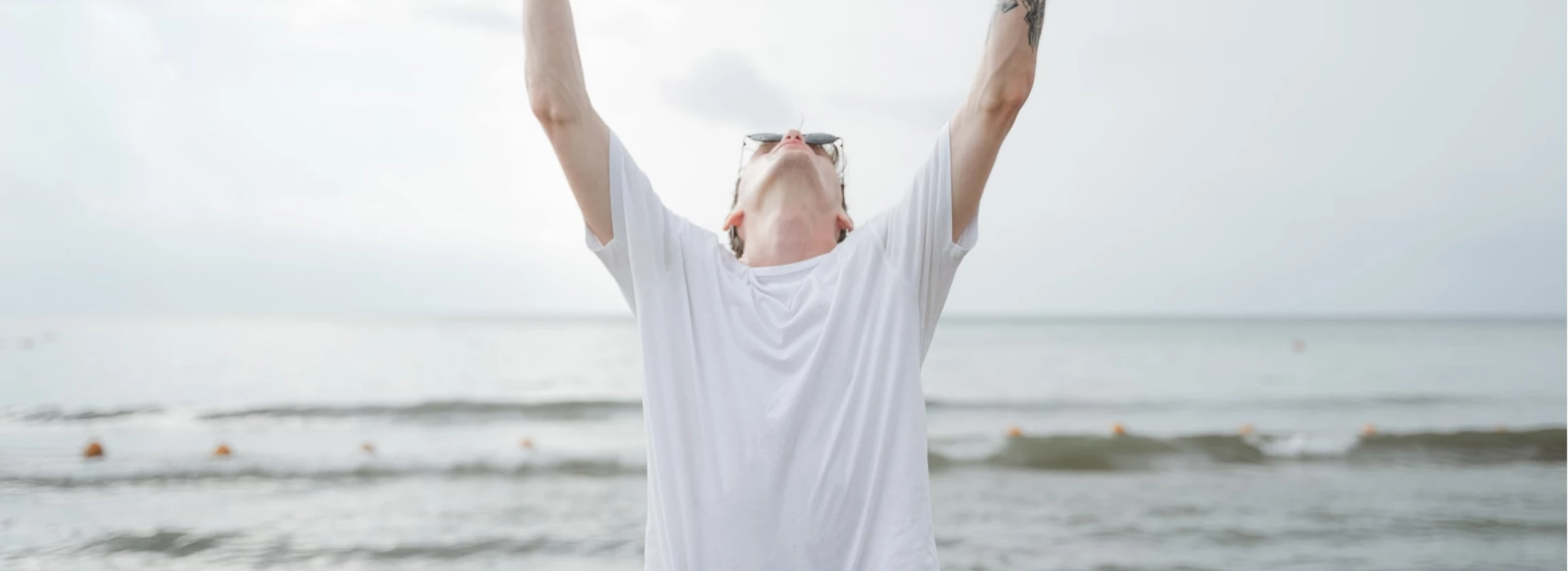 young guy raised his hands looking up addresses to heaven