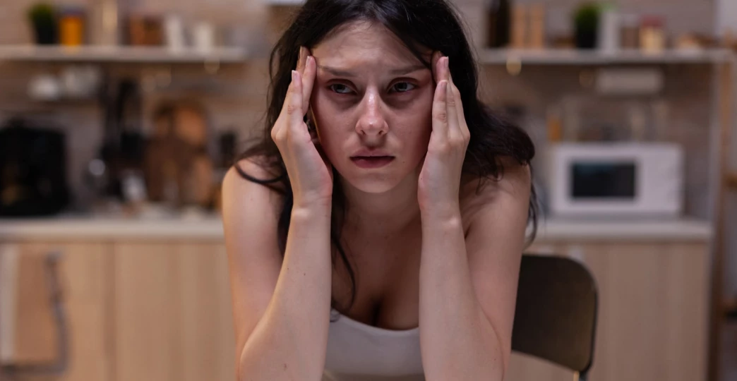 portrait of upset woman with serious headache pain