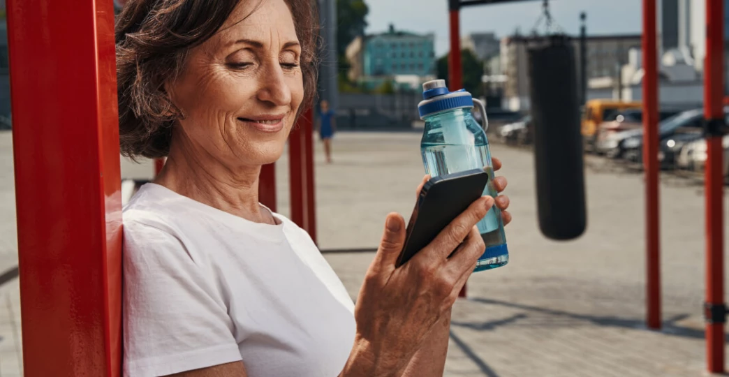 Aged women chating via mobile phone and smiling