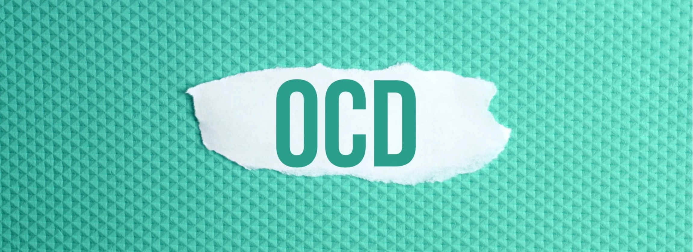 obsessive compulsive disorder a torn paper written with inscription OCD on a green background