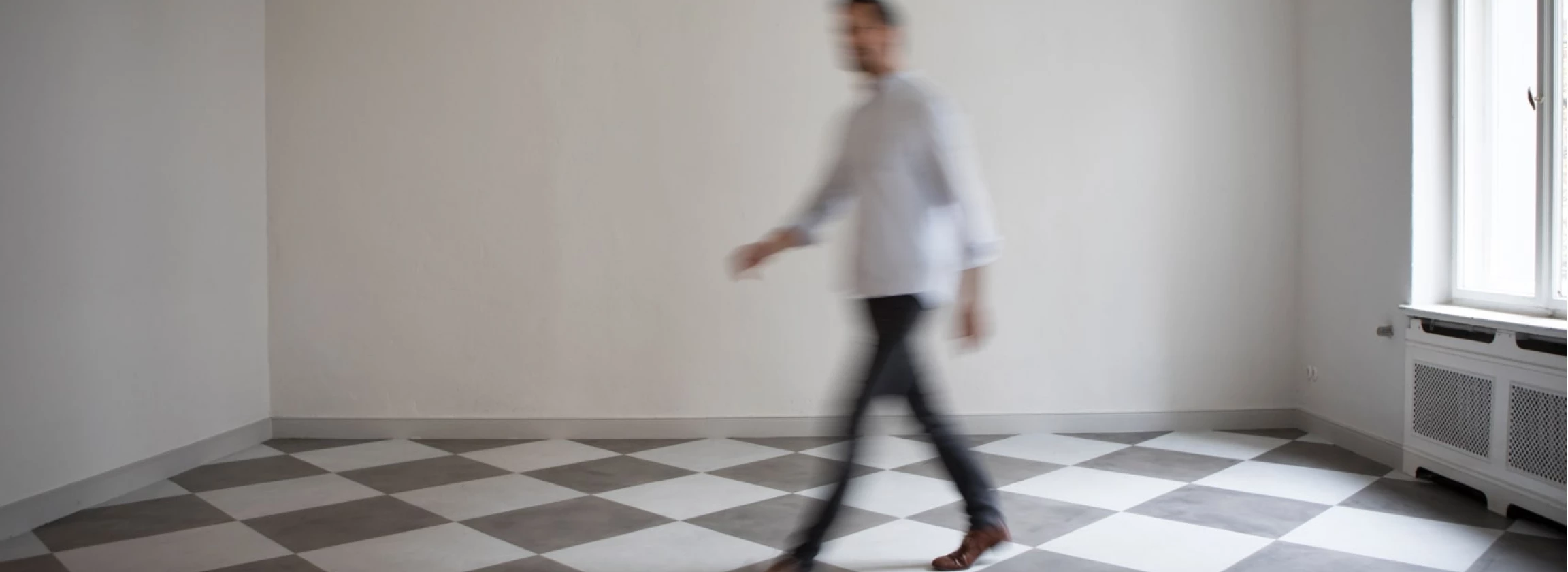 man crossing empty room of an apartment