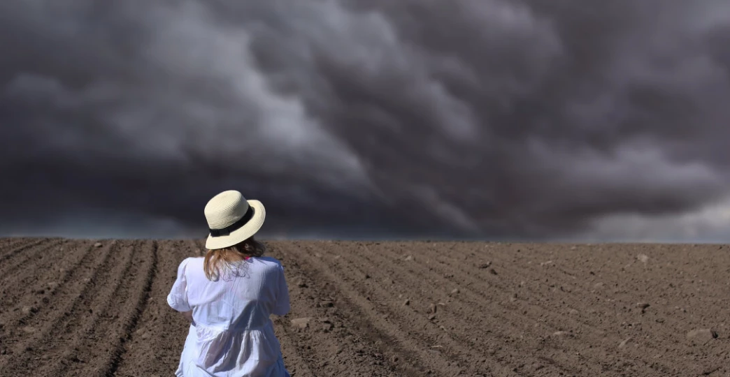 Women staring at stormy sky