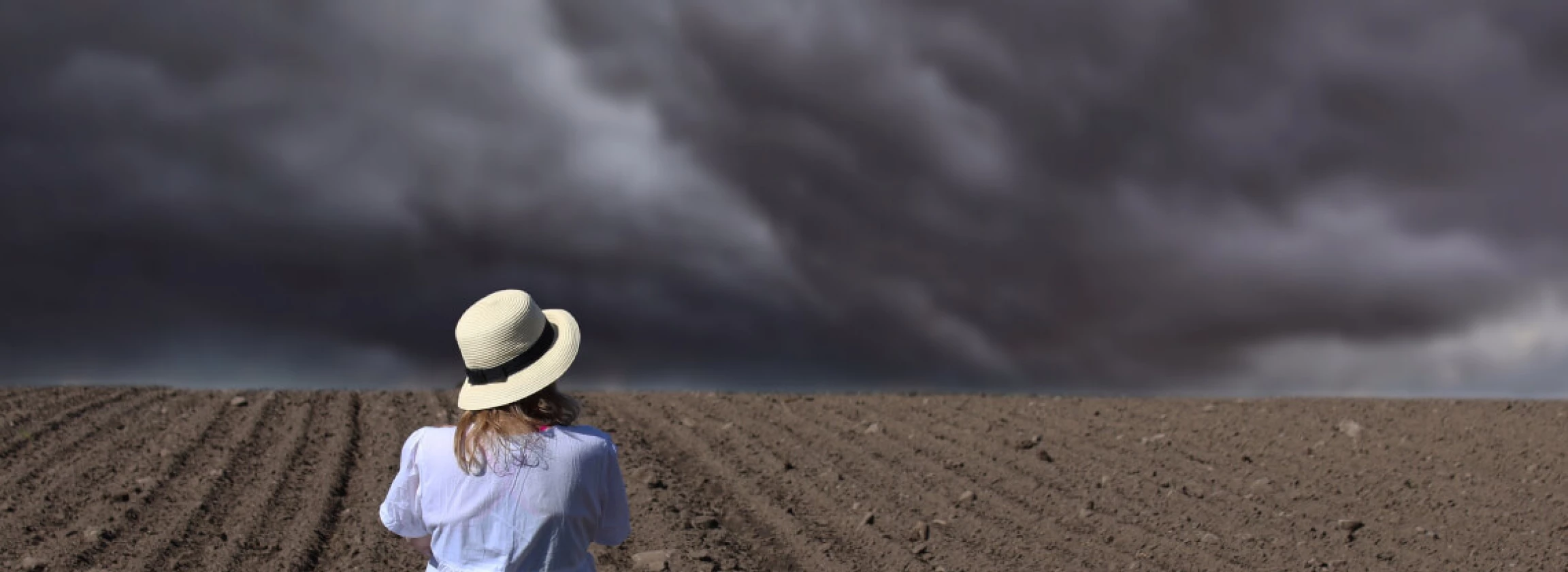 Women staring at stormy sky