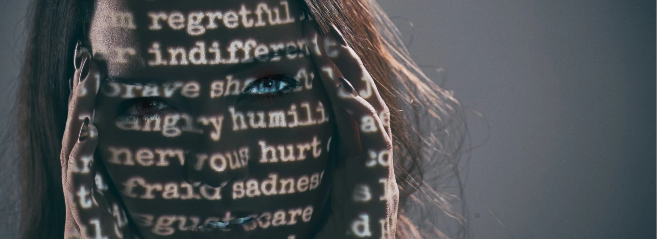 woman with projected words on her face and hands