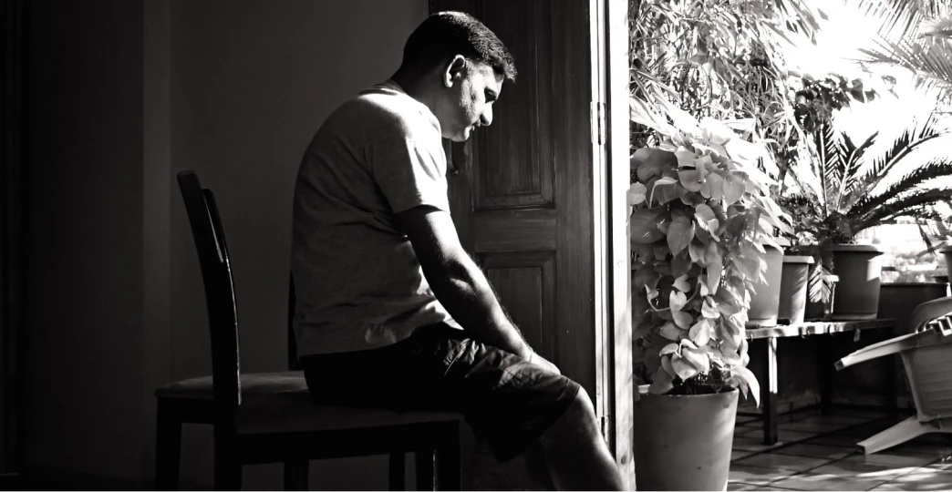 man sitting alone having intrusive thoughts