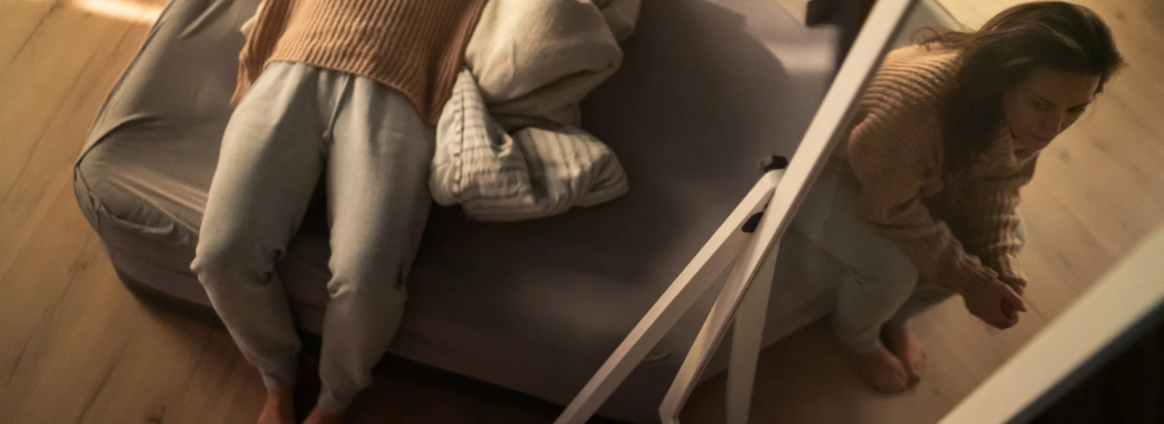mid adult sad woman suffering from multiple personality disorders lying and sitting on bed