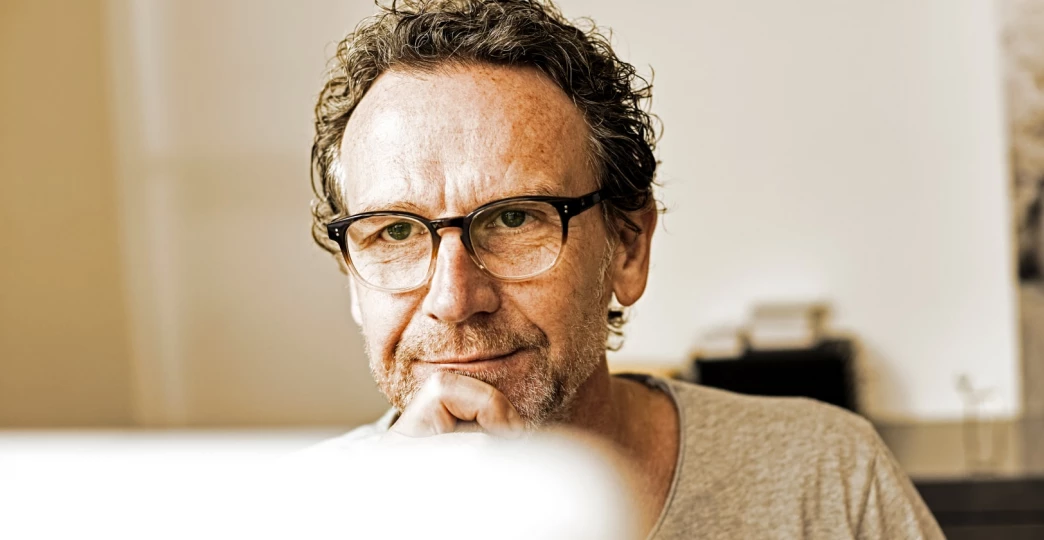 portrait of pensive man looking at computer