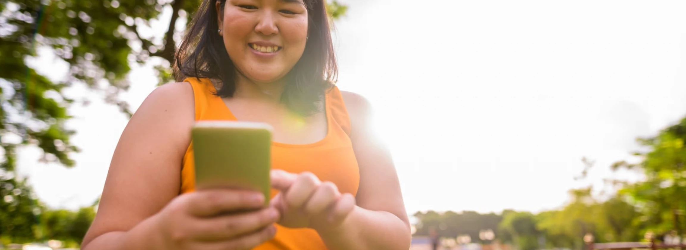 An overweight woman happy with a phone