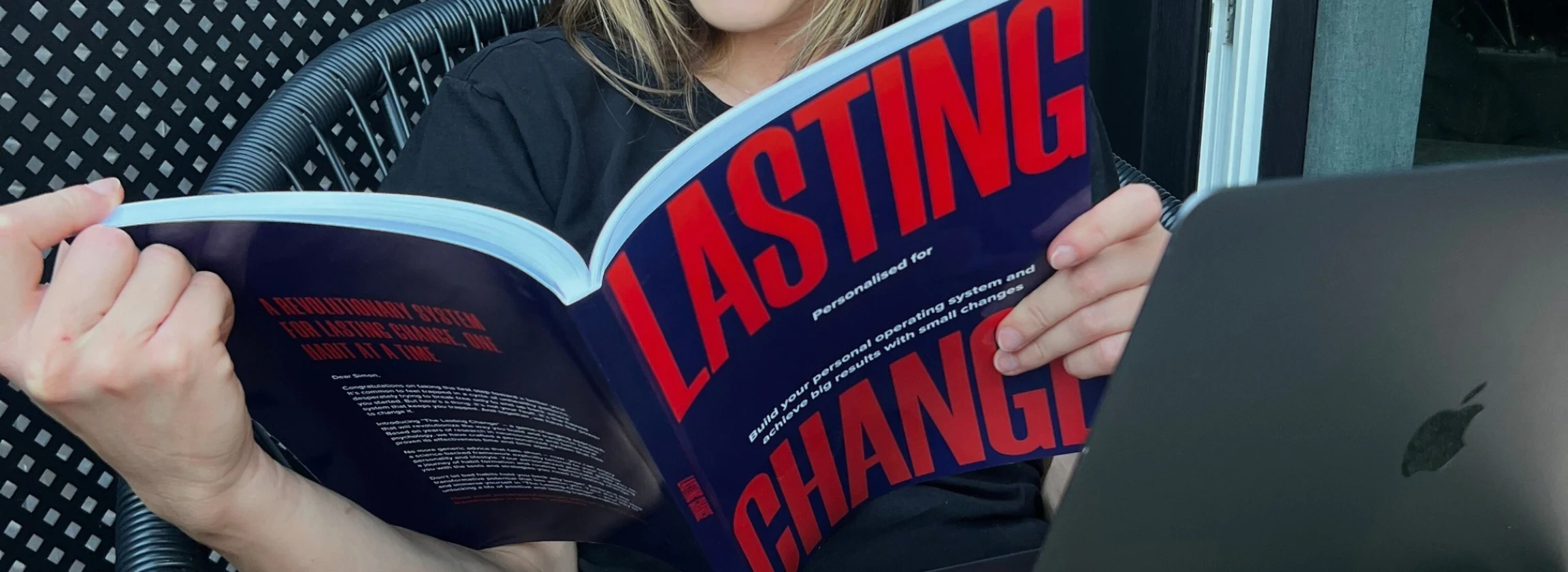 Woman reading the Lasting Change book