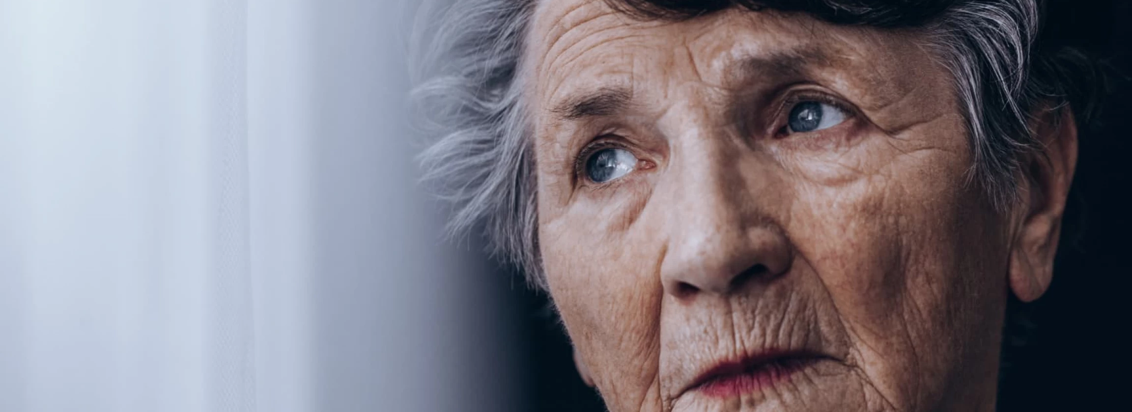 Sad old woman notably alone