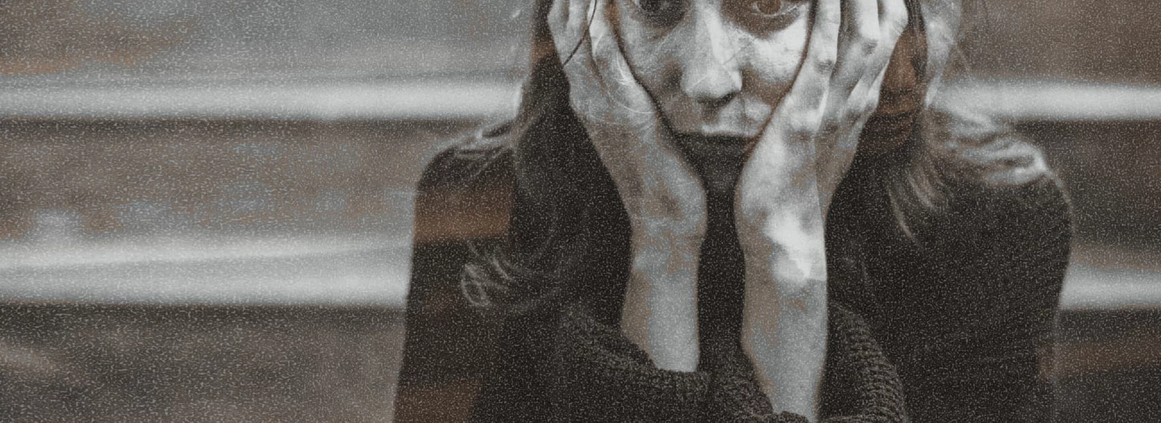 Distressed woman sitting on a staircase thinking deeply