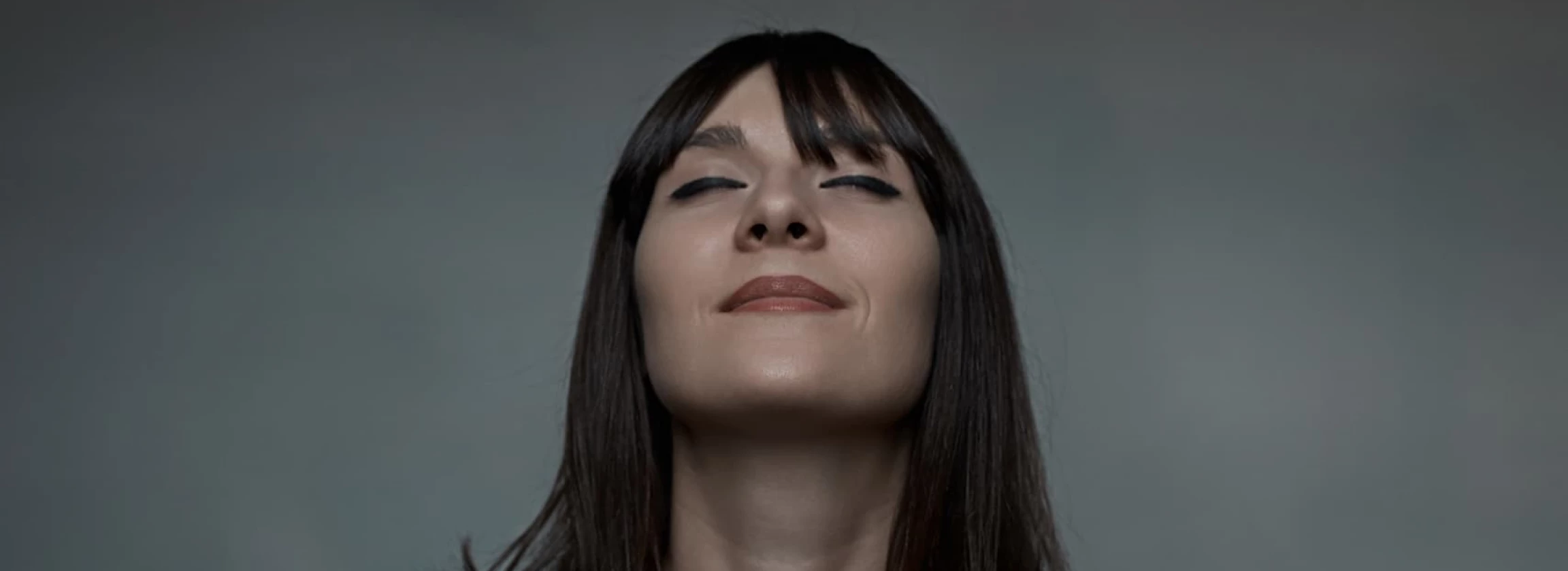 close up portrait of woman embracing herself