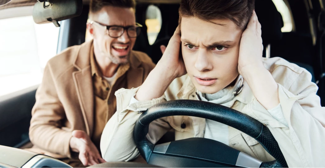 irritated father yelling at teen son in car
