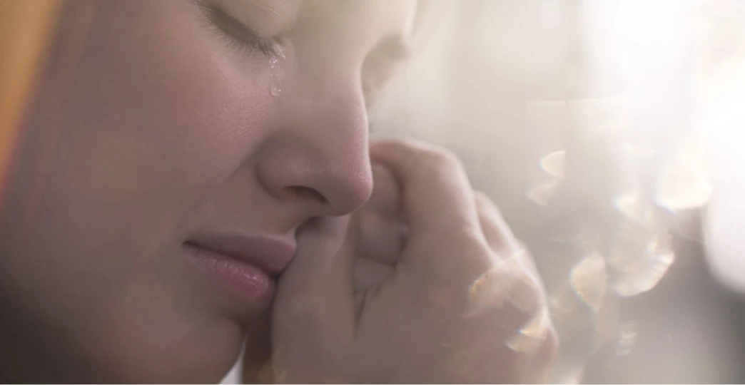 close up of face of crying sad teenager with emotional problem