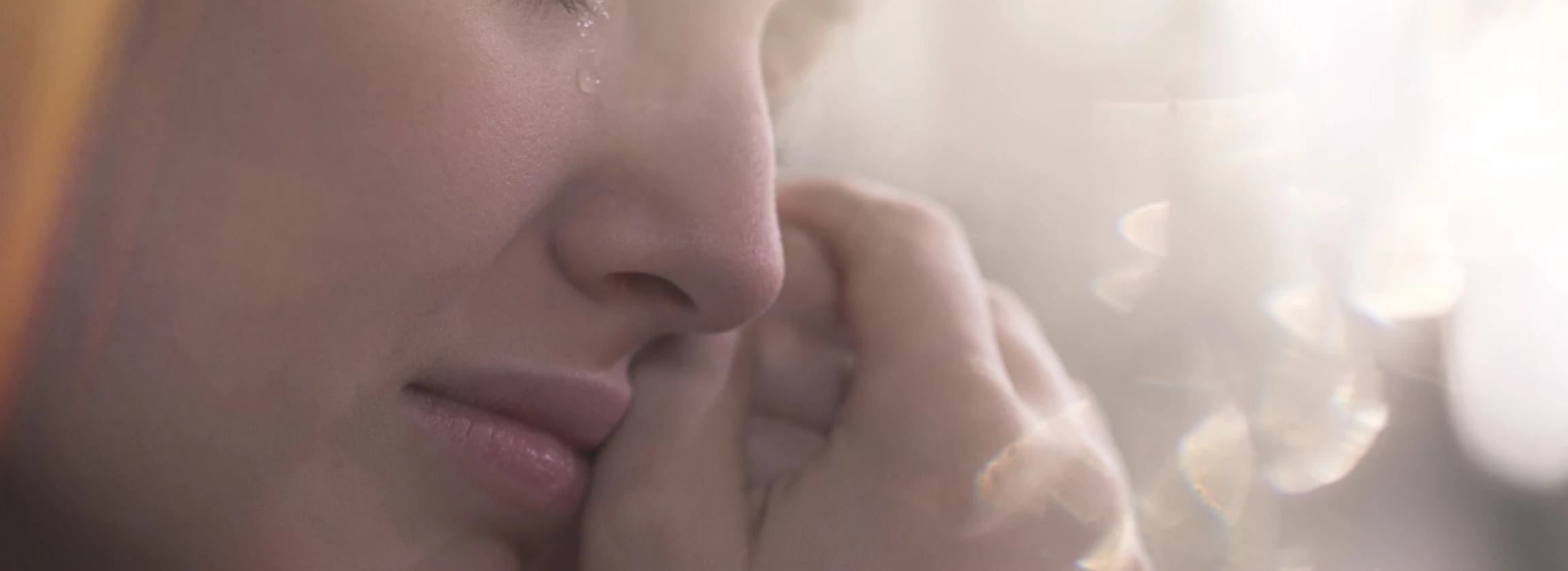 close up of face of crying sad teenager with emotional problem